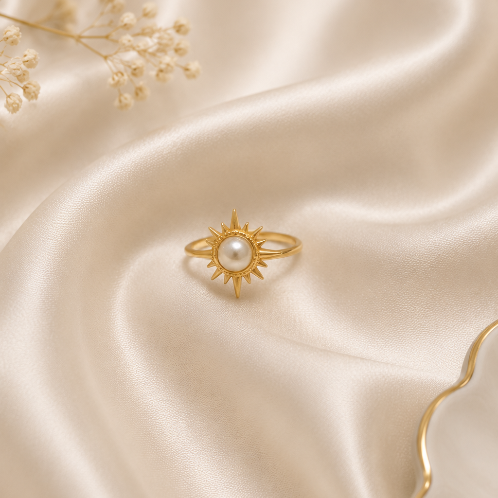 Gold ring with pearl on a beige satin background